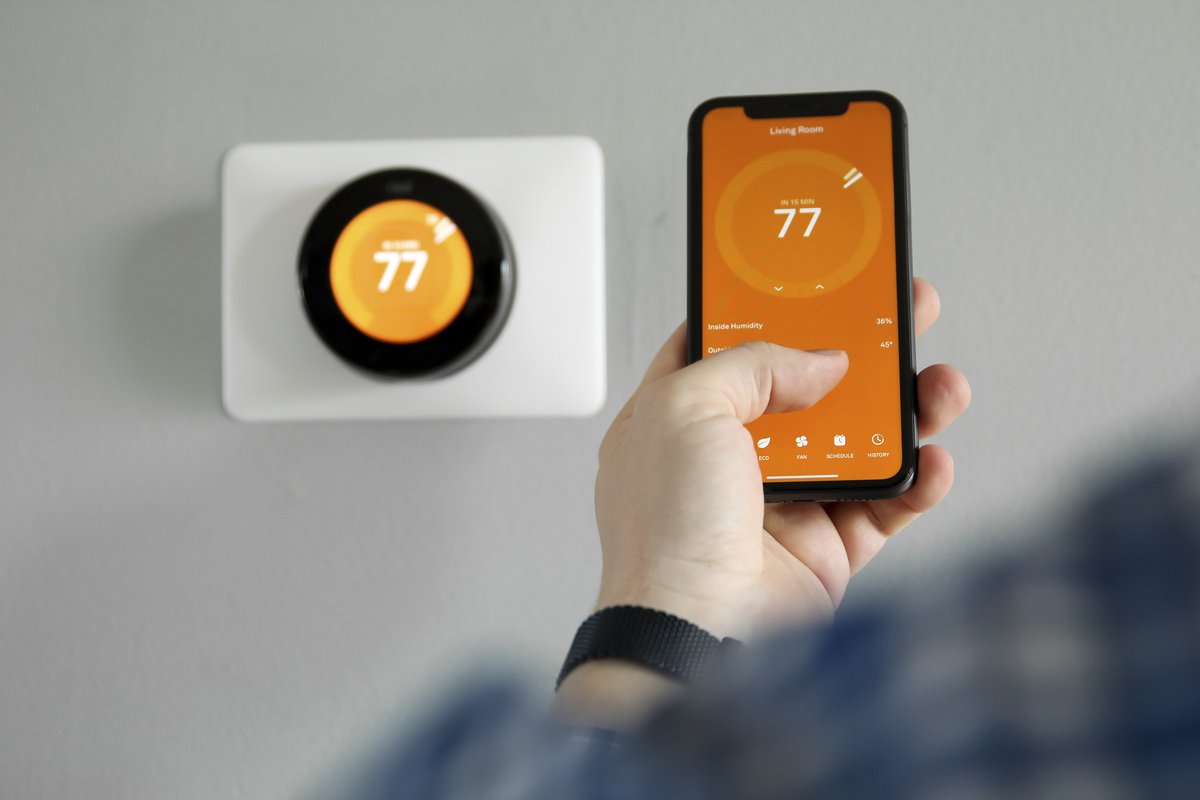 Smart thermostat controlled by phone app, installed by Archvolt Electric